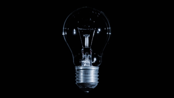 Tungsten Light Bulb Lamp Blinking Over Black Background