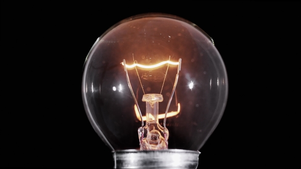 Edison Lamp Light Bulb Blinking Over Black Background
