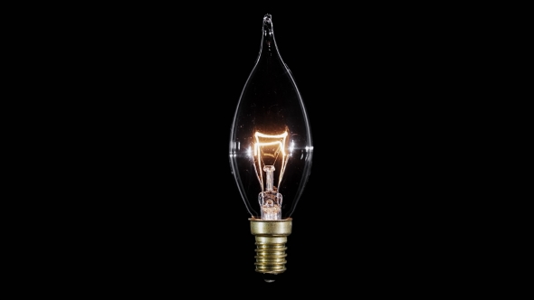 Candle Shaped Lamp Light Bulb Flickers Over Black Background