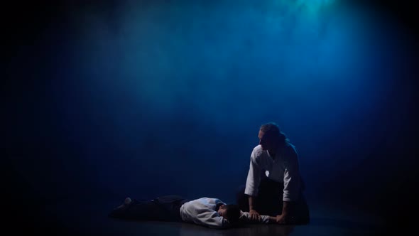 Two Fighters Participants of the Training in Special Clothes of Aikido Hakama Work Out the Methods alt
