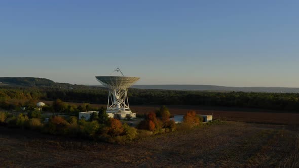 Aerial Drone Shot of Telecommunications Antenna or Radio Telescope Satellite Dish on Sunset alt