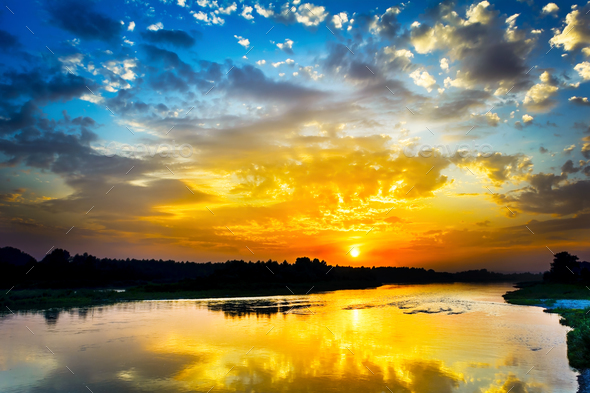 Beautiful lake landscape with vivid sunrise on the cloudy sky - Stock Photo - Images