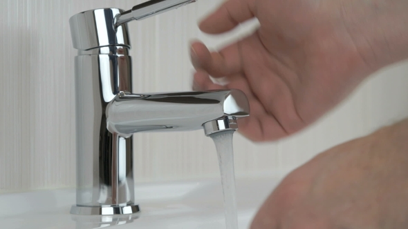 Man Washing Hands In The Bathroom alt