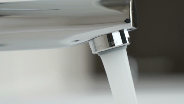Strong Water Pressure Flowing From a Chrome Tap