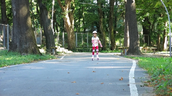 Rollerblading In The Park. Girl Rides On Roller Skates. On Rollers On a Track. alt