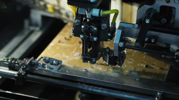 Pick-and-Place Machine Installing Components on PCB in a Factory alt