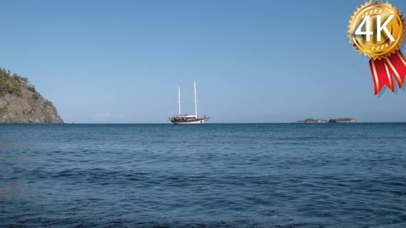 Yacht With Tourists Infront of the Island in the