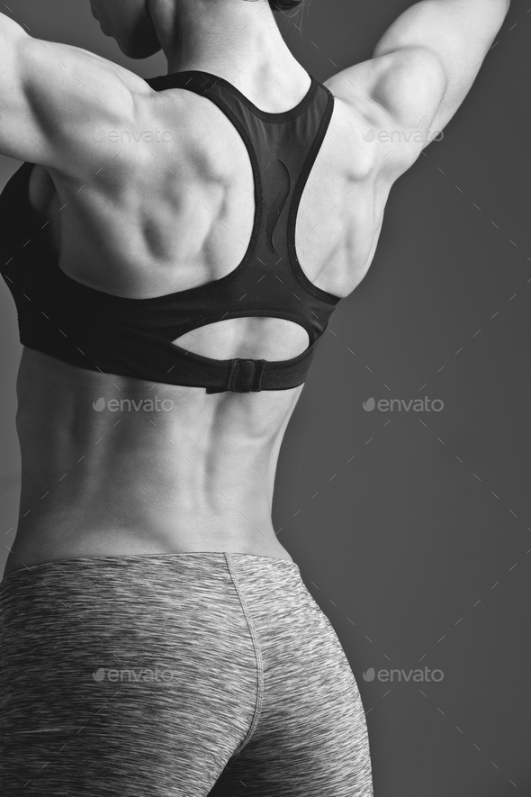 Sporty girl back with muscles Stock Photo by Svetography
