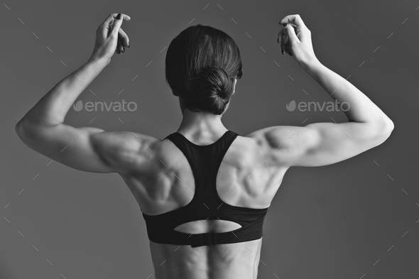 Sporty girl back with muscles Stock Photo by Svetography