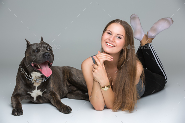 Beautiful girl with grey stafford terrier - Stock Photo - Images