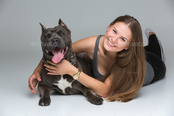 Beautiful girl with grey stafford terrier - Stock Photo - Images