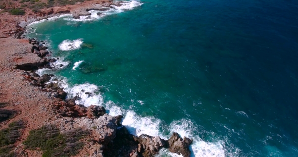 Blue Sea, Waves Breaking In Cliffs At Shore