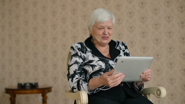 Cheerful Senior Woman Connected By Skype