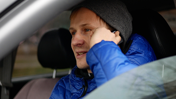 Man In Car Talking On Phone alt