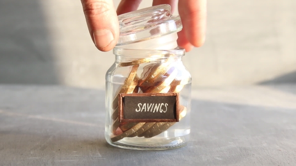 Savings Concept, Money Into a Glass