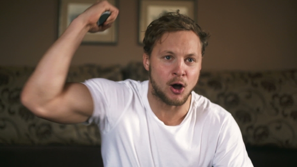 Handsome Man Watching Football Match In His Living Room, Stock Footage