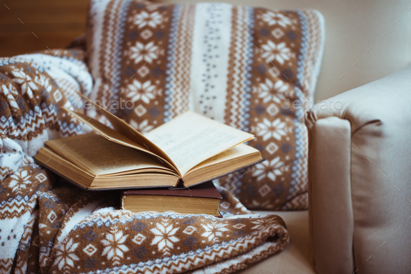 Stack of books with warm plaid on chair - Stock Photo - Images