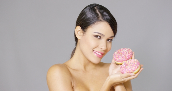 Gorgeous Smiling Woman Holding Donuts alt