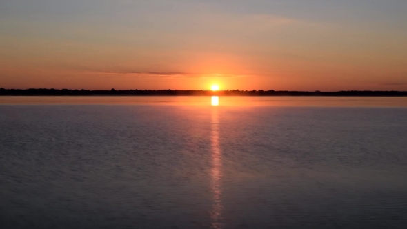 Sunrise Over Water with Morning Mist