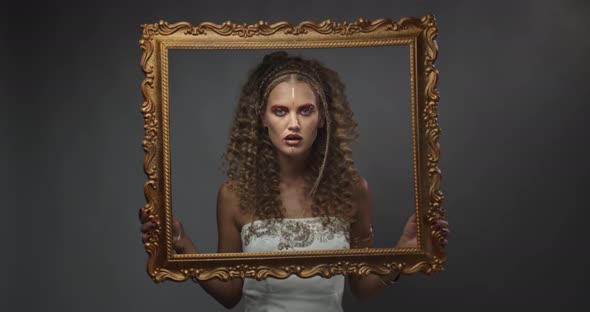 Model Is Posing in the Studio with the Gold Picture Frame, Fashion,  alt