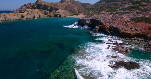 Blue Sea, Waves Breaking In Cliffs At Shore