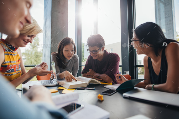 University students doing group study in library - Stock Photo - Images
