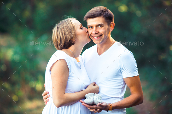 Pregnant wife and her husband in park - Stock Photo - Images