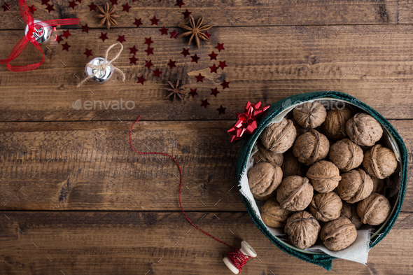 Walnuts in Christmas Tin with Festive Decorations on Rustic Table - Stock Photo - Images