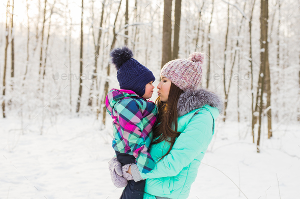 Young brunette mother with her daughter outdoors. Winter time - Stock Photo - Images