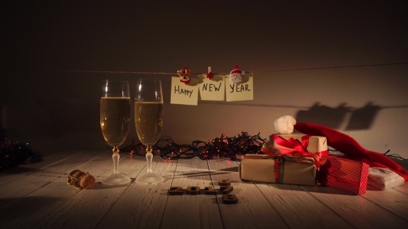 New Year and Christmas Celebration with Champagne. Two Flutes and Pouring Sparkling Wine From the
