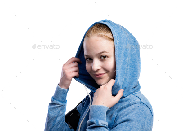 Teenage girl in blue sweatshirt. Studio shot, isolated. Stock Photo by  halfpoint