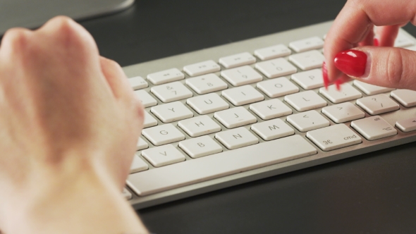 Woman Typing on a Keyboard and Making Gestures alt