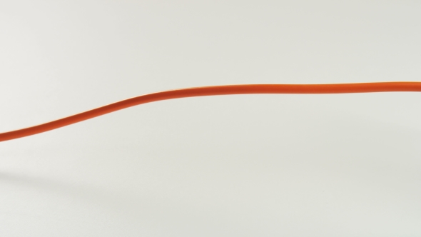 Orange Cable Plugged To a Power Board alt