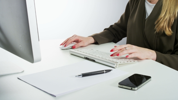 Woman Using Mouse and Typing on a Keyboard alt