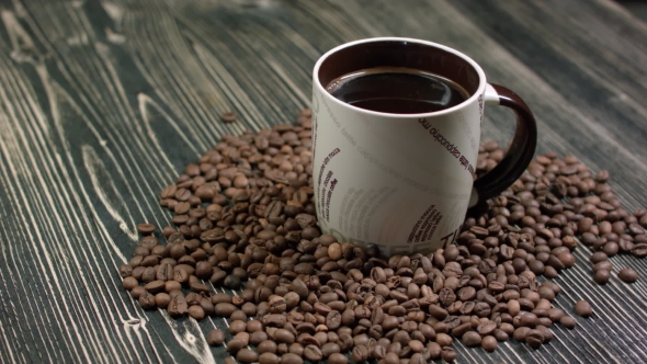 Coffee Cup with Roasted Coffee Beans on Wooden Background alt