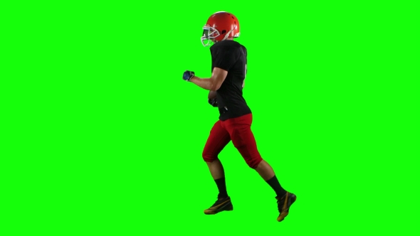 Football Player Running with the Ball in His Helme alt