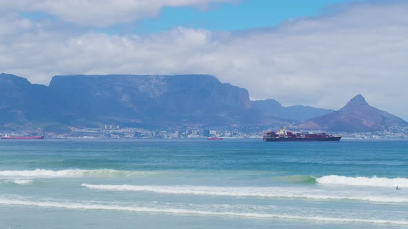 Beautiful Clear Day Looking to Table Mountain and Mother City with Ocean Waves Crashing Over Rocky alt