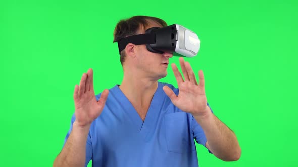 Medical Man with Virtual Reality Headset or 3d Glasses. Green Screen alt