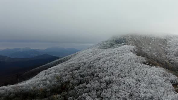 A Mountainous Vista of Snowcapped Peaks and Frostcovered Forests