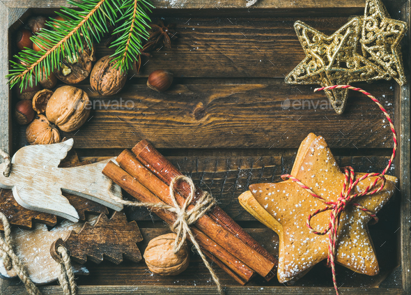 Sweet cookies, wooden angels, decorative golden stars, nuts, cinnamon sticks - Stock Photo - Images