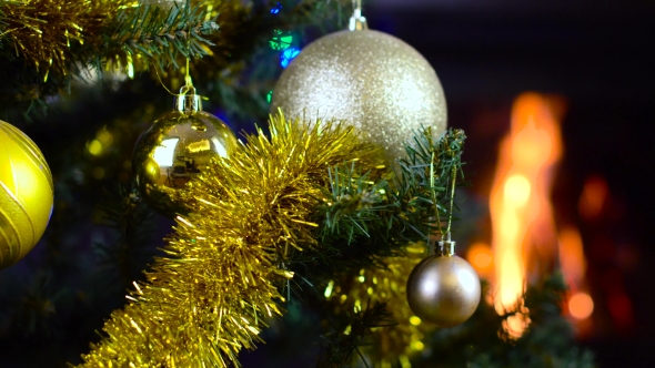 Decorated Christmas Tree with Lights in Front of Fireplace