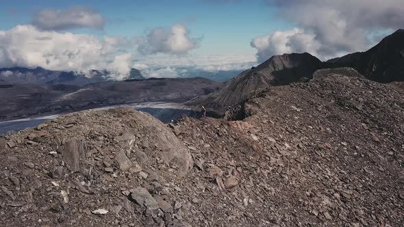 Mountaineering Man Hiking on Rocky Mountain Ridge in High Caucasus Mountains