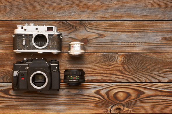 Vintage old cameras and lenses on wooden background - Stock Photo - Images