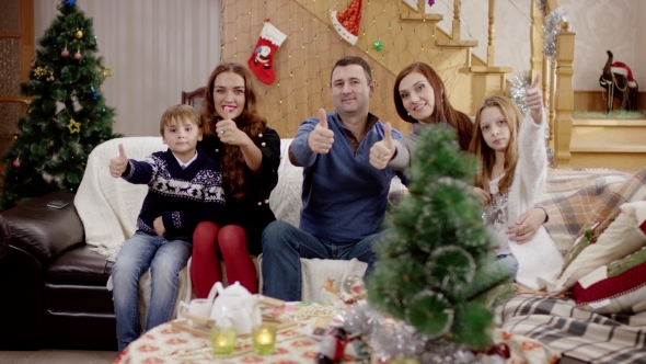 Family Showing Thumb Up at Christmas Party