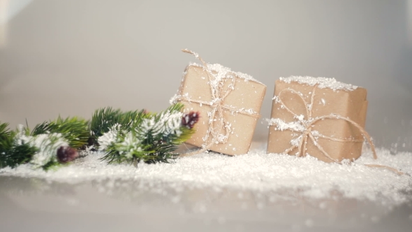 Christmas Boxes for Gifts and Branches in the Snow on a White Background