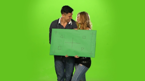Energetic and  Beautiful Couple Holding Up a Blank Sign, Green Screen alt