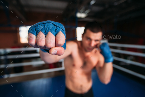 Boxer in blue wrist wraps on the training.