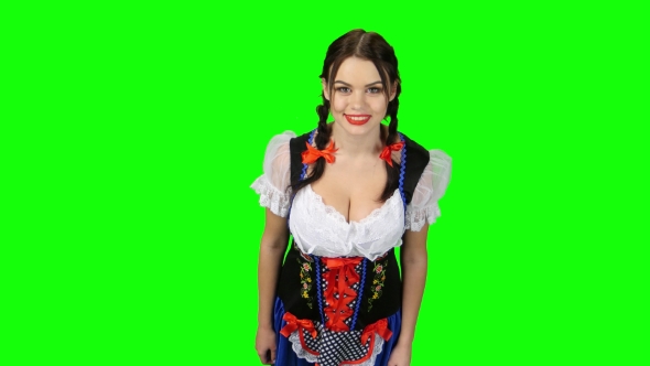 Girl in Bavarian Costume Shows Thumb Up. Green Screen. View From Above alt