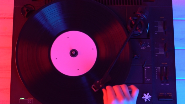 A Man Starting a Retro Record Player, Lay Down the Stylus and Listen To Music