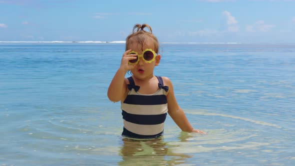 Adorable Little Girl on Warm and Sunny Summer Day on the Coastline Indian Ocean alt